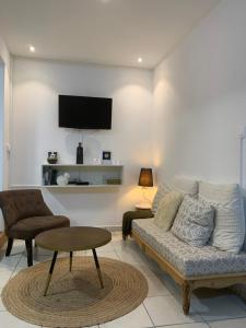 a living room with a couch and a table at Locastudio - Carambole in Sainte-Anne