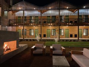 a building with chairs and a fireplace in front of it at Cotton Court Hotel, by Valencia Hotel Collection in Lubbock