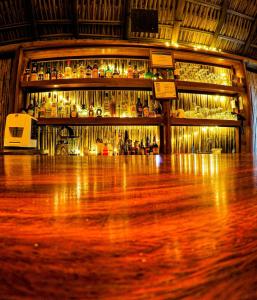 a room with a bar with a wooden floor at Casa Lu Hotel Boutique in Mazunte