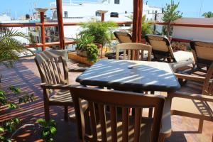 a patio with a table and chairs on a balcony at Cande's Apartments in Isla Mujeres