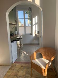 a kitchen with a table and a chair in a room at La Chapelle in Mamers +9 photos