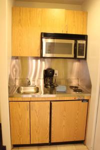 a kitchen with a sink and a microwave at St Moritz Lodge and Condominiums in Aspen