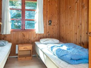 a bedroom with two beds and a window at Three-Bedroom Holiday home in Toftlund 25 in Arrild