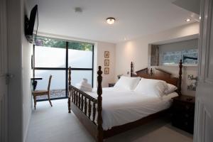 a bedroom with a large bed and a window at The Old Bushmills Barn in Bushmills