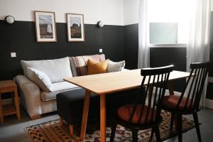 a living room with a table and a couch at The Auld Kirk & Spa in Stirling