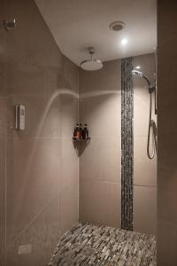 a shower in a bathroom with a glass shower at The Auld Kirk & Spa in Stirling