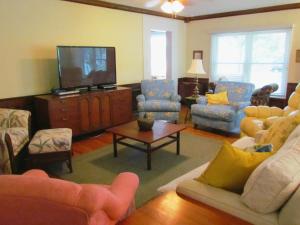 sala de estar con muebles y TV de pantalla plana en Ardendales, en Brooksville