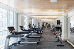 a gym with a row of treadmills and exercise bikes at Hyatt Centric Center City Philadelphia in Philadelphia