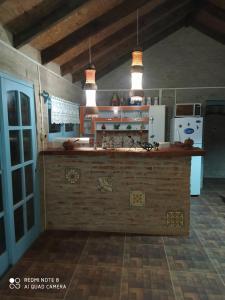 a kitchen with a counter and a refrigerator at Techos Amarillos II in Aguas Dulces