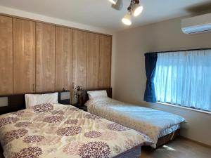 Een bed of bedden in een kamer bij Platinum Yasaka