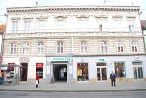 a white building on the corner of a street at Hyde Park Hostel in Bratislava
