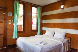 מיטה או מיטות בחדר ב-Baan Kitsada