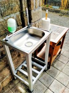 a kitchen sink with a faucet and a table at Anyar Estate in Canggu