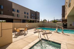 a patio with a table and chairs and a pool at Holiday Inn Express & Suites Chatsworth, an IHG Hotel in Chatsworth