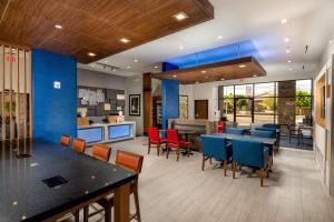 a restaurant with blue walls and tables and chairs at Holiday Inn Express & Suites Chatsworth, an IHG Hotel in Chatsworth