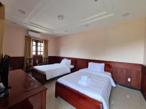Postel nebo postele na pokoji v ubytování Con Dao Tan Son Nhat Hotel