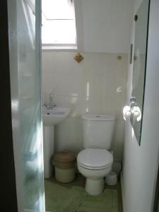 a small bathroom with a toilet and a sink at Avebury Life in Avebury