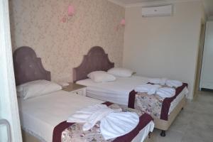 Postel nebo postele na pokoji v ubytování Turk Hotel