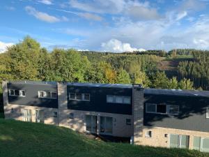 an aerial view of a building with trees in the background at Les Terrasses de Malmedy 22 Studio 341 in Malmedy