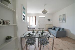 a living room with a table and chairs and a couch at ALLORO APPARTAMENTO 1 - Piano Terra con terrazza. in Sirmione