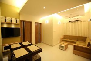 a living room with a couch and a table at Casa Allay in Cochin