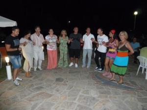 a group of people standing in a group at a party at Pension Delfini in Asprovalta