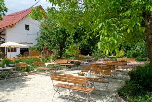 un grupo de mesas y sillas bajo un árbol en Hotel Zum Fischerwirt, en Baindlkirch