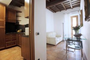 a kitchen and living room with a table and a couch at Borgo Pio 91 in Rome
