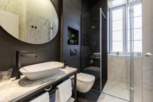 a bathroom with a sink and a toilet and a shower at DeZign Superior Apartments & Rooms in Zadar +37 photos