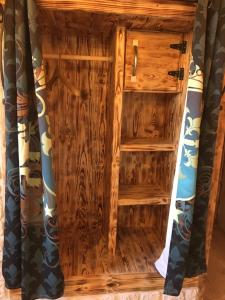 a wooden cabinet in a room with a curtain at chambre d'hôte medieval du vieux bourg in Chailloué +14 photos