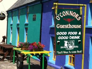 a sign on a cart in front of a building at O'Connors Guesthouse in Faha
