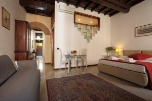 a bedroom with a bed and a table and a couch at Borgo Pio 91 in Rome