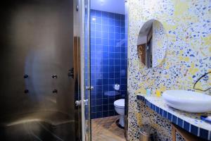 a bathroom with a toilet and a sink and a mirror at Hotel Boutique Sabbia Valencia in Valencia