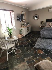 a bedroom with a bed and a table and chair at Robinson Retreat in Darlington