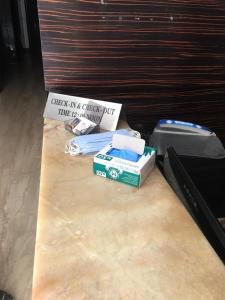 a table with a suitcase and a sign on it at Hotel Metro View in New Delhi