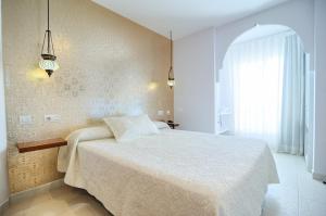 a bedroom with a bed and a large window at Hotel Boutique Sabbia Valencia in Valencia