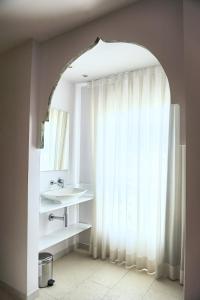 a bathroom with a sink and a window at Hotel Boutique Sabbia Valencia in Valencia