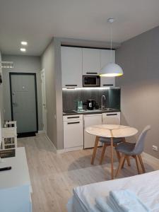 a kitchen with a table and a dining room at Studio Galaxy 2 floor in Kyiv