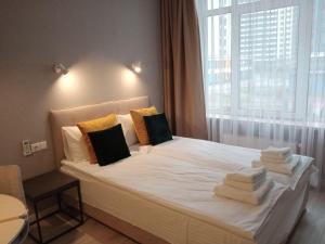 a bedroom with a bed with towels on it at Studio Galaxy 2 floor in Kyiv