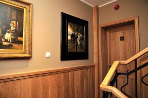 a hallway with a painting on the wall and a staircase at Apartamenty Kopernika 14 in Toruń