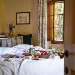 a tray of fruits and vegetables on a bed at Fonte De' Medici in San Casciano in Val di Pesa