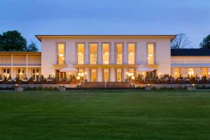 a large building with a lawn in front of it at Dolce by Wyndham Bad Nauheim in Bad Nauheim