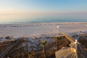 an aerial view of a beach with palm trees at Escapes! To The Shores Orange Beach, A Ramada by Wyndham in Orange Beach