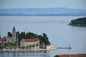 a church on an island in the middle of a lake at Apartment Diva in Vis