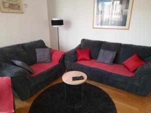 a living room with two couches and a table at Apartment Pavlito in Dubrovnik