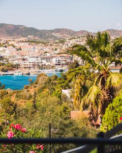 a view of a city with a palm tree and water at Dalya Resort Aqua & Spa Hotel Datça in Datca