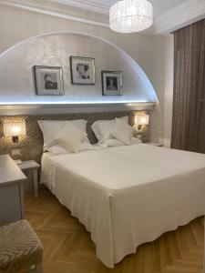Postel nebo postele na pokoji v ubytování Hotel Aurelia