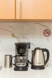 a coffee maker and kettle on a kitchen counter at Manina SeaSide Apartment in Thessaloniki