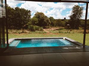a swimming pool in the yard of a house at Elements Private Golf Reserve in Bela-Bela
