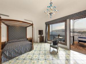 a bedroom with a bed and a view of the water at Hotel La Tonnarella in Sorrento